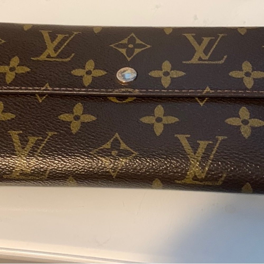 Brown wallet with snap closure and many inside compartments